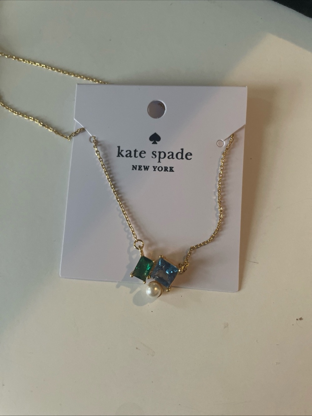 kate spade gold necklace with blue & green stones and pearl charm
